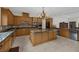 Gourmet kitchen featuring custom cabinets, granite countertops, and stainless steel appliances at 11944 Dolcemente Ln, Las Vegas, NV 89138