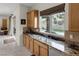 Stylish kitchen with stainless steel appliances, granite countertops, and a view of the pool at 11944 Dolcemente Ln, Las Vegas, NV 89138