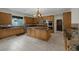 Large kitchen featuring an island, granite countertops, and stainless steel appliances at 11944 Dolcemente Ln, Las Vegas, NV 89138