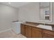 Laundry room features a washer, dryer, and counter space with a sink and cabinets at 11944 Dolcemente Ln, Las Vegas, NV 89138
