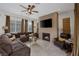 Inviting living room with fireplace, large sectional, and natural light at 11944 Dolcemente Ln, Las Vegas, NV 89138
