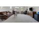 Spacious living room with a comfortable leather sofa, armchairs, and a TV console, ideal for relaxation and entertainment at 11944 Dolcemente Ln, Las Vegas, NV 89138