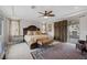 Comfortable main bedroom with carpeted floors, ceiling fan, and a private door to the outdoor patio at 11944 Dolcemente Ln, Las Vegas, NV 89138