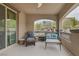Cozy covered patio with comfortable seating, offering a relaxing outdoor space with views of the landscaped backyard at 11944 Dolcemente Ln, Las Vegas, NV 89138