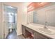 Bright bathroom with double sinks, a shower and a separated toilet room for added privacy at 1425 Bow Creek Ct, Las Vegas, NV 89128
