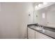 Powder room with a granite countertop, sink, and a large mirror at 1425 Bow Creek Ct, Las Vegas, NV 89128