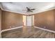Large bedroom with a ceiling fan, a walk-in closet, and multiple windows for natural light at 1425 Bow Creek Ct, Las Vegas, NV 89128