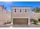 Beige home garage exterior showcasing a spacious driveway on a sunny day at 1425 Bow Creek Ct, Las Vegas, NV 89128