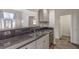 Kitchen with black countertops, stainless steel sink and pass through to adjacent room at 1425 Bow Creek Ct, Las Vegas, NV 89128
