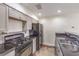 Kitchen with white cabinets, black appliances and black countertops in a clean space at 1425 Bow Creek Ct, Las Vegas, NV 89128