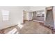 Open-concept living area with a stone accent floor that connects to the kitchen and the staircase at 1425 Bow Creek Ct, Las Vegas, NV 89128