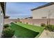 Lush backyard featuring well-maintained artificial grass, a brick perimeter and privacy wall at 1634 Deep Valley Ave, North Las Vegas, NV 89084