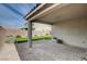 The backyard features a paved patio, a small patch of grass, and block wall fencing at 1634 Deep Valley Ave, North Las Vegas, NV 89084
