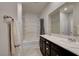 Well-lit bathroom featuring double sinks, vanity, shower and tub combination, and neutral tile flooring at 1634 Deep Valley Ave, North Las Vegas, NV 89084