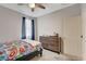 Bedroom featuring a closet, ceiling fan, dresser, and neutral carpet at 1634 Deep Valley Ave, North Las Vegas, NV 89084