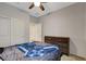 This bedroom features a ceiling fan, closet, neutral walls, and a wooden dresser at 1634 Deep Valley Ave, North Las Vegas, NV 89084