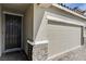 This house features desert landscaping, an attached two-car garage, and a dark front door at 1634 Deep Valley Ave, North Las Vegas, NV 89084