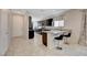 Bright kitchen with breakfast bar, granite countertops, dark cabinetry, and tiled floors at 1634 Deep Valley Ave, North Las Vegas, NV 89084