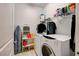 Efficient laundry room with washer, dryer, shelving and storage space at 1634 Deep Valley Ave, North Las Vegas, NV 89084