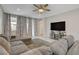 A comfortable living room features tile flooring and large windows for ample natural light at 1634 Deep Valley Ave, North Las Vegas, NV 89084
