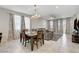 Open-concept living and dining area with abundant natural light, tile flooring, and modern decor at 1634 Deep Valley Ave, North Las Vegas, NV 89084