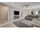 Open-concept living room with tile floors, ceiling fan, and views into the dining and kitchen areas at 1634 Deep Valley Ave, North Las Vegas, NV 89084