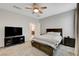 Comfortable bedroom featuring a ceiling fan, plush carpet, and warm natural light at 1634 Deep Valley Ave, North Las Vegas, NV 89084