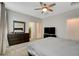 Spacious main bedroom featuring a ceiling fan, large dresser, and ensuite bathroom access at 1634 Deep Valley Ave, North Las Vegas, NV 89084