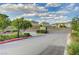 This street view showcases the gated entrance to the community on a sunny day at 1634 Deep Valley Ave, North Las Vegas, NV 89084