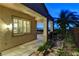 Covered back patio with stone pillars, a built-in grill, and city views in the distance at 1637 Wellington Springs Ave, Henderson, NV 89052