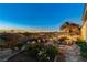 Lush landscaped backyard with mature plants and beautiful city views at 1637 Wellington Springs Ave, Henderson, NV 89052