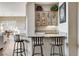 Charming bar area featuring granite countertops, glass-front cabinets, and seating for three at 1637 Wellington Springs Ave, Henderson, NV 89052