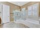 Bathroom with a large walk-in shower, separate soaking tub, and natural light from window at 1637 Wellington Springs Ave, Henderson, NV 89052
