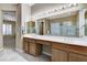 Bathroom featuring double sink vanity, ample countertop space, walk in shower, and tiled floor at 1637 Wellington Springs Ave, Henderson, NV 89052