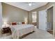 Cozy bedroom featuring neutral paint, natural light, and easy access to the ensuite bathroom at 1637 Wellington Springs Ave, Henderson, NV 89052