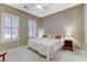 Comfortable bedroom with carpeted floors, natural light, and neutral paint at 1637 Wellington Springs Ave, Henderson, NV 89052