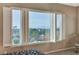 Bright bedroom with a view of the mountains visible through the large window with plantation shutters at 1637 Wellington Springs Ave, Henderson, NV 89052
