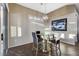 This breakfast nook includes wood floors, decor lighting, and views to the outdoors at 1637 Wellington Springs Ave, Henderson, NV 89052