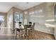 Charming breakfast nook features modern light fixture, picture window and sliding glass door access to the exterior at 1637 Wellington Springs Ave, Henderson, NV 89052