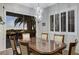 Formal dining room featuring a modern light fixture, plantation shutters, and a beautiful view at 1637 Wellington Springs Ave, Henderson, NV 89052