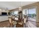 The dining room features a dark wood table, wood floors, decorative lighting, and mountain views at 1637 Wellington Springs Ave, Henderson, NV 89052