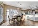 This dining area features a modern light fixture and plantation shutters allowing light into the open and airy space at 1637 Wellington Springs Ave, Henderson, NV 89052