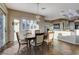 The dining room includes wood floors, decorative lighting, and large bright windows at 1637 Wellington Springs Ave, Henderson, NV 89052