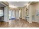 Open entryway with tile flooring, glass front door, decorative mirror and views to the living spaces at 1637 Wellington Springs Ave, Henderson, NV 89052
