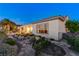 Landscaped backyard with stone pathways, vibrant flowers, and a view of the home's exterior at 1637 Wellington Springs Ave, Henderson, NV 89052