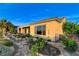 Exterior view features a well-maintained backyard with lush plantings and a covered patio at 1637 Wellington Springs Ave, Henderson, NV 89052