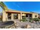 Rear exterior view showcases covered patio, manicured landscaping, and hot tub at 1637 Wellington Springs Ave, Henderson, NV 89052