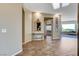 Inviting foyer with wood-look tile flooring and decorative mirror leading to the living areas at 1637 Wellington Springs Ave, Henderson, NV 89052