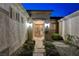 Charming front entrance with double doors, stone pathway, and manicured landscaping with warm lighting at 1637 Wellington Springs Ave, Henderson, NV 89052