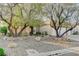 Charming front exterior with well-maintained landscaping, mature trees, and a welcoming entrance at 1637 Wellington Springs Ave, Henderson, NV 89052